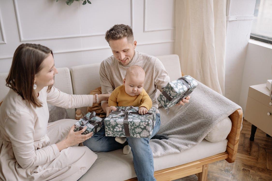 Free Parents with Child Unpacking Presents at Home Stock Photo